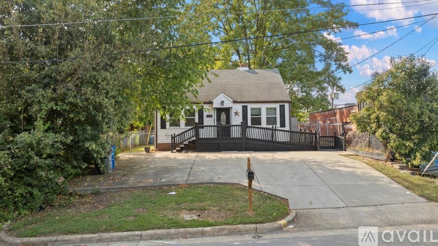 A house with a black fence and a small front yard.
