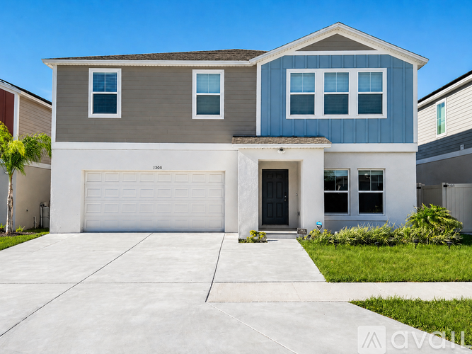 A modern two-story house with a garage.