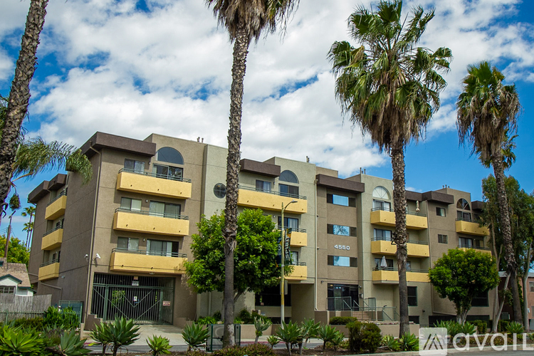 A building with palm trees in front of it.