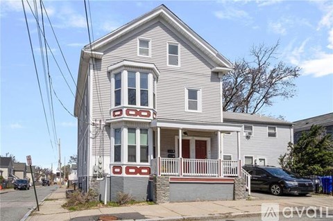 A two-story house with a porch and a balcony.