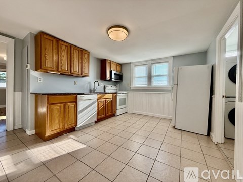 A kitchen with wooden cabinets and a white refrigerator.