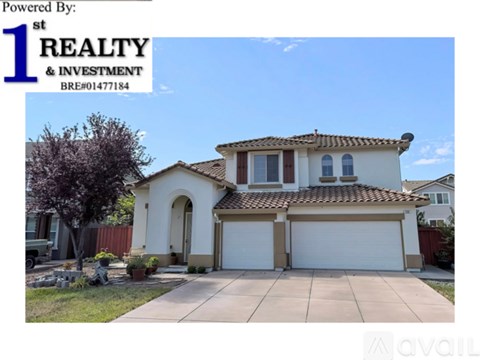 A house with a white garage door and a brown roof is for sale.