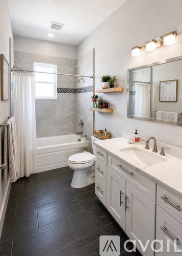 A bathroom with a toilet, sink, and mirror.