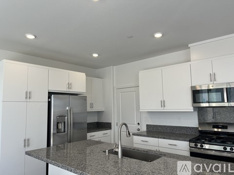 A kitchen with granite countertops and stainless steel appliances.
