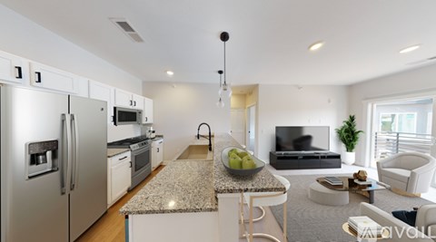A modern kitchen with a refrigerator, microwave, oven, and sink.