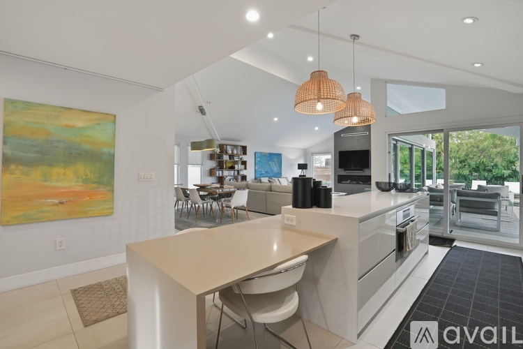 A modern kitchen with a dining table and chairs.