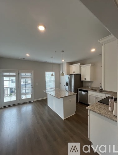 A kitchen with a refrigerator, microwave, and oven is available for rent.