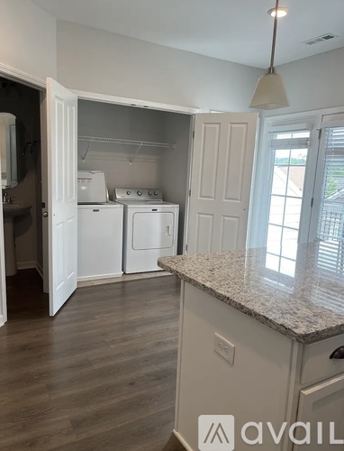 A kitchen with white appliances and a granite countertop.