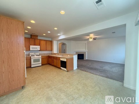 A kitchen with wooden cabinets and a white stove top oven.