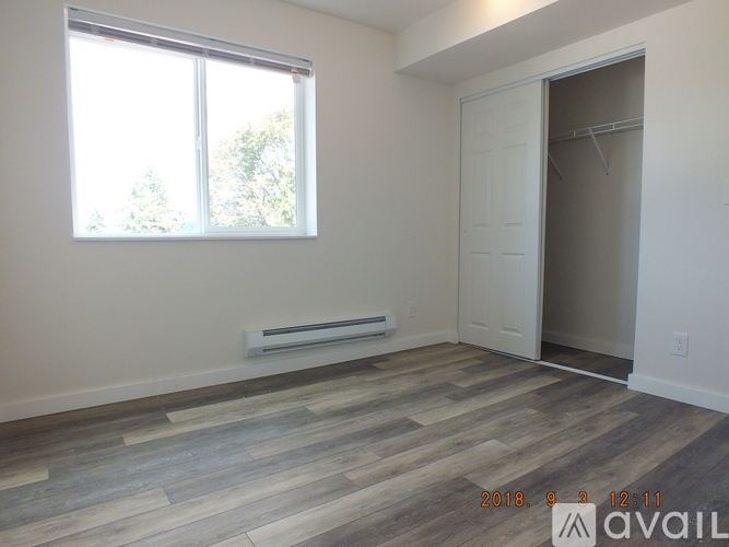 A room with a window and a door is available for rent.