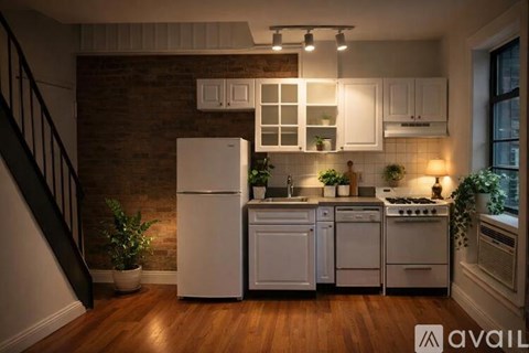 A kitchen with a refrigerator, oven, and sink.