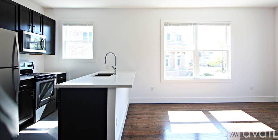 A kitchen with black appliances and a white countertop.