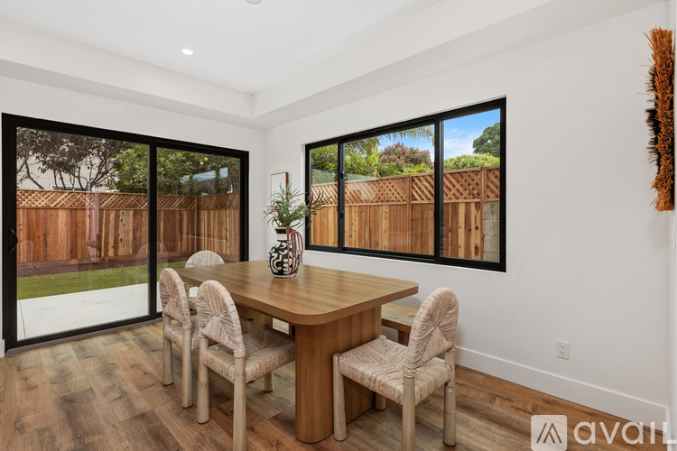 A dining room with a wooden table and chairs.