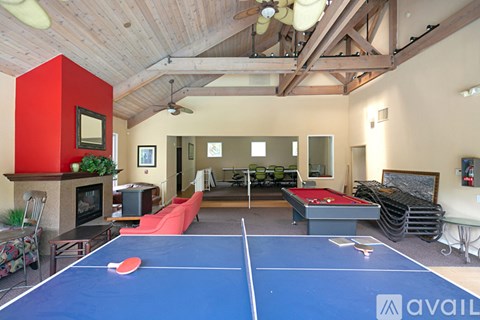 A ping pong table is in the middle of a living room.