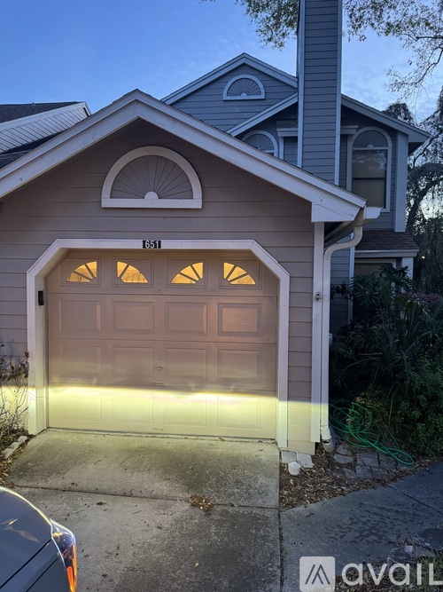 A house with a garage that has the number 1351 on it.