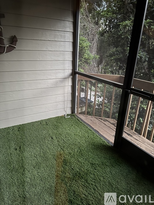 A room with a green carpet and a white wall.