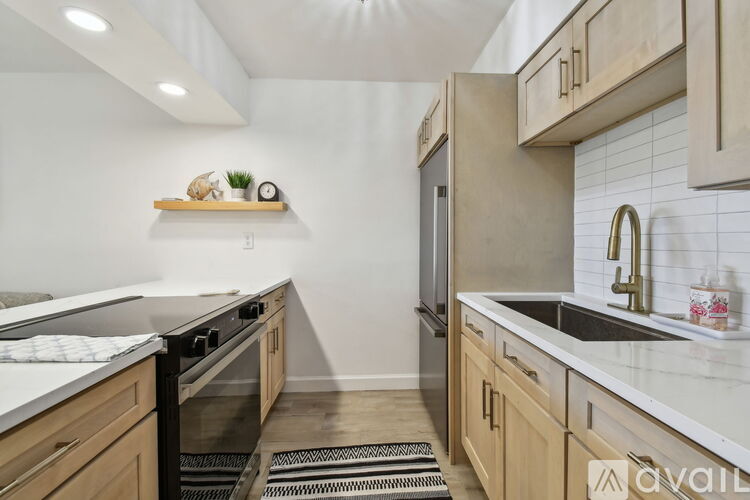 A kitchen with wooden cabinets and a black oven.
