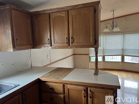 A kitchen with wooden cabinets and a countertop.
