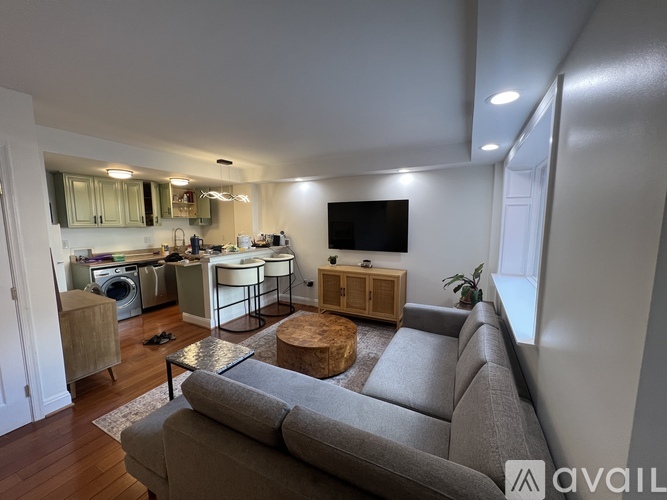 A living room with a grey couch and a wooden coffee table.