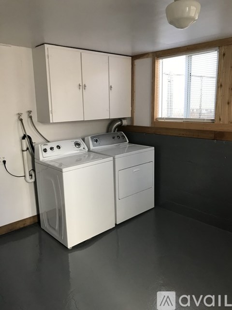 A white dishwasher and washing machine in a kitchen.