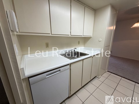 A small kitchen with a dishwasher and a sink.