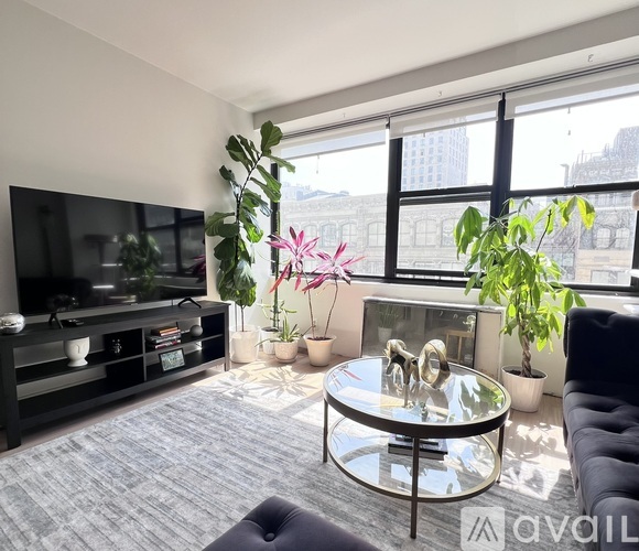 A living room with a glass table and a television.