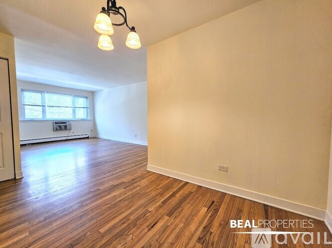 A room with wooden flooring and a window is available for rent.