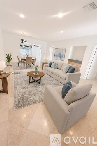 A living room with a grey couch and a coffee table.