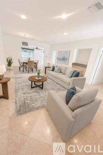 A living room with a grey couch and a coffee table.