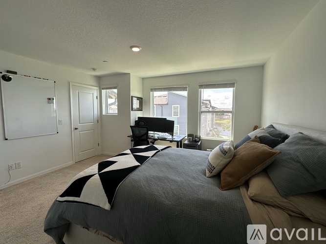 A bedroom with a large bed and a television in the corner.
