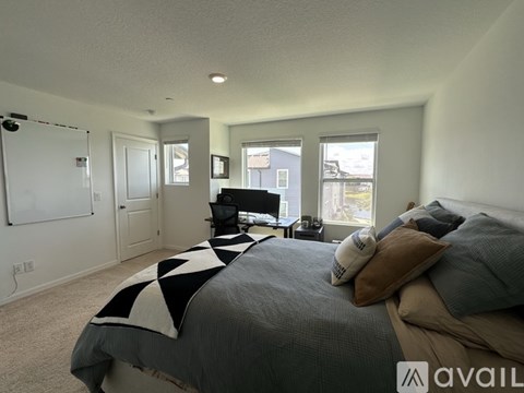 A bedroom with a large bed and a television in the corner.