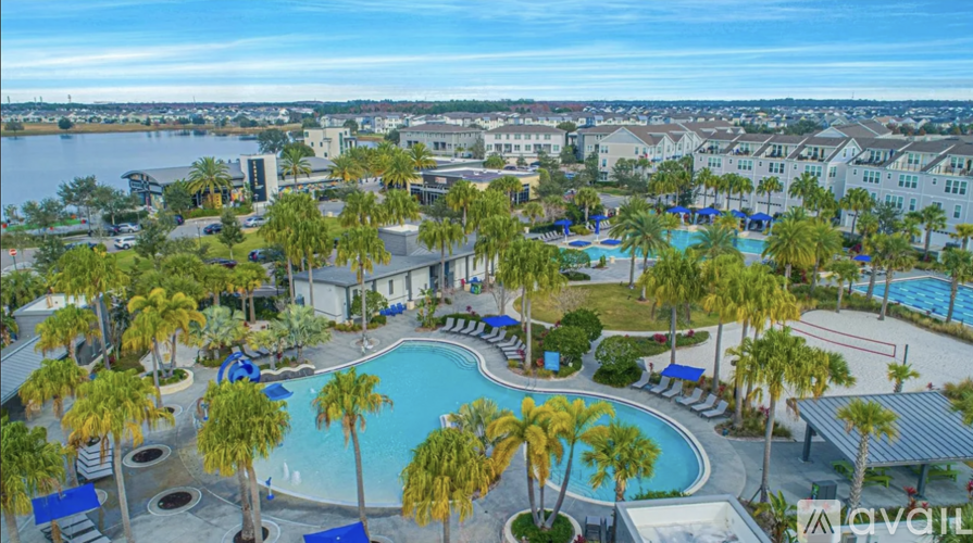 A view of a resort with a pool and palm trees.