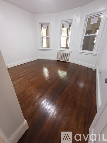 A room with wooden floors and white walls.