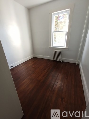 A room with wooden floors and a window.