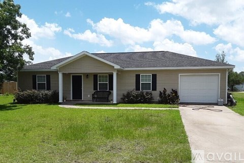 A house with a grey roof and a white garage door.