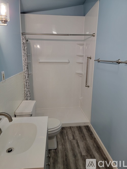 A white sink is in a bathroom with blue walls.