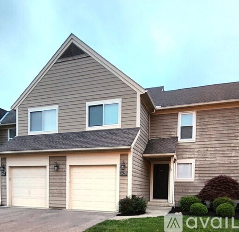 A two-story house with a garage on the lower level.
