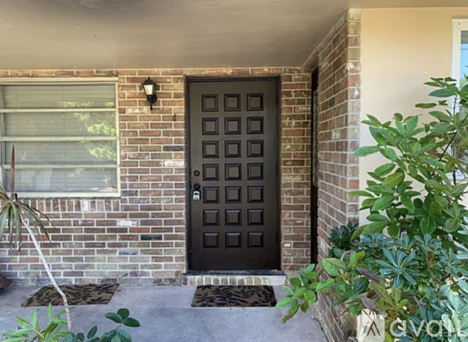 A black door is on the front of a house.