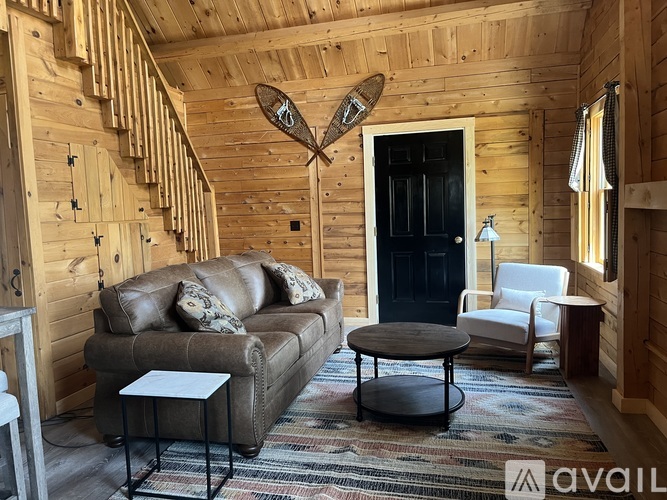 A living room with a couch, chair, and coffee table.