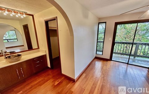 A kitchen with wooden floors and a counter with a bowl on it.