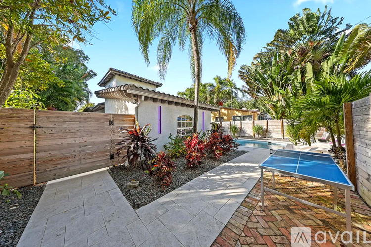 A backyard with a pool and a house.