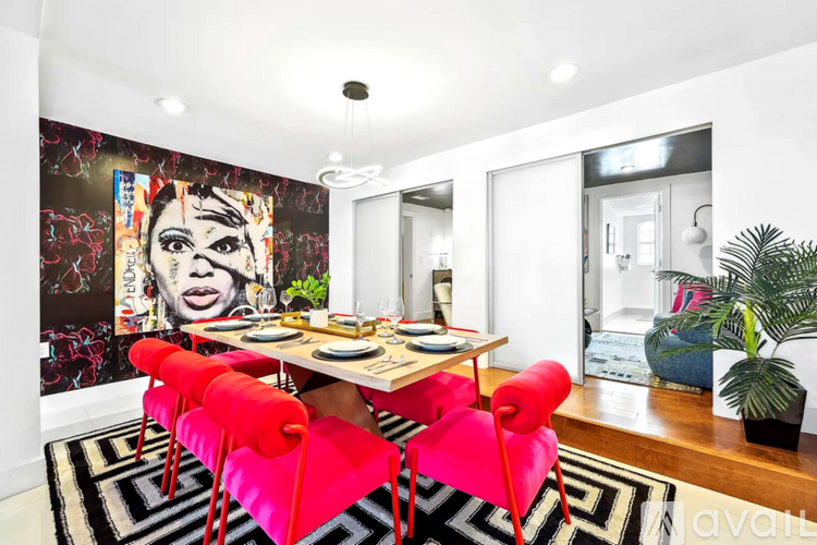 A dining room with a table and chairs.