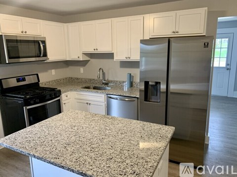 A kitchen with granite countertops and stainless steel appliances.
