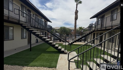 A row of houses with a palm tree in the background.