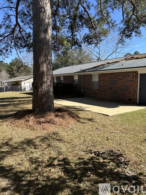A house with a tree in front of it.