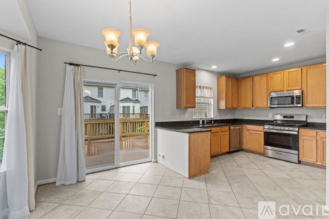 A kitchen with wooden cabinets and a black countertop.