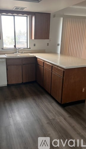 A kitchen with wooden cabinets and a white countertop.