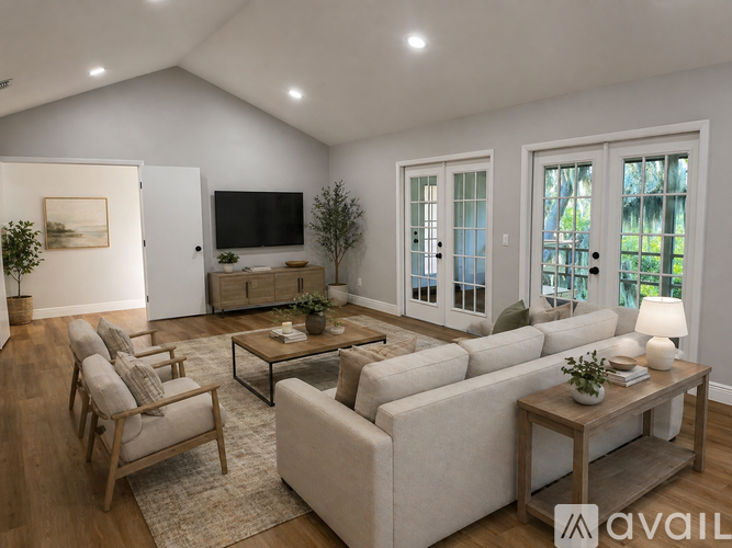 A living room with a couch, chairs, and a coffee table.