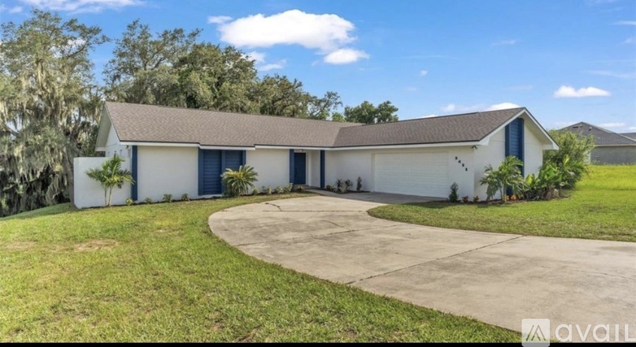 A house with a white and blue exterior is available for sale.