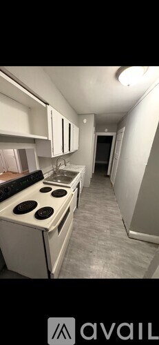 A kitchen with white appliances and cabinets.